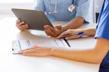 Fototapeta premium close up of doctors with tablet pc at hospital
