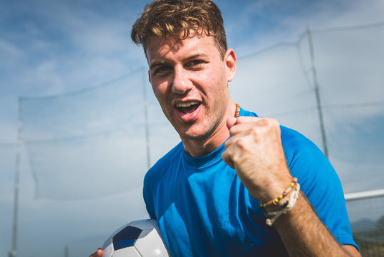 Happiness football player after goal on the field of stadium