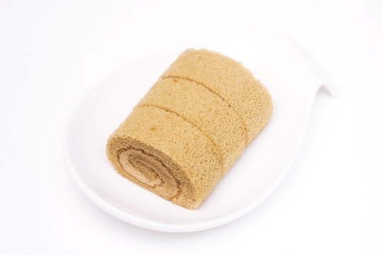 Roll cake in cup on a white background 