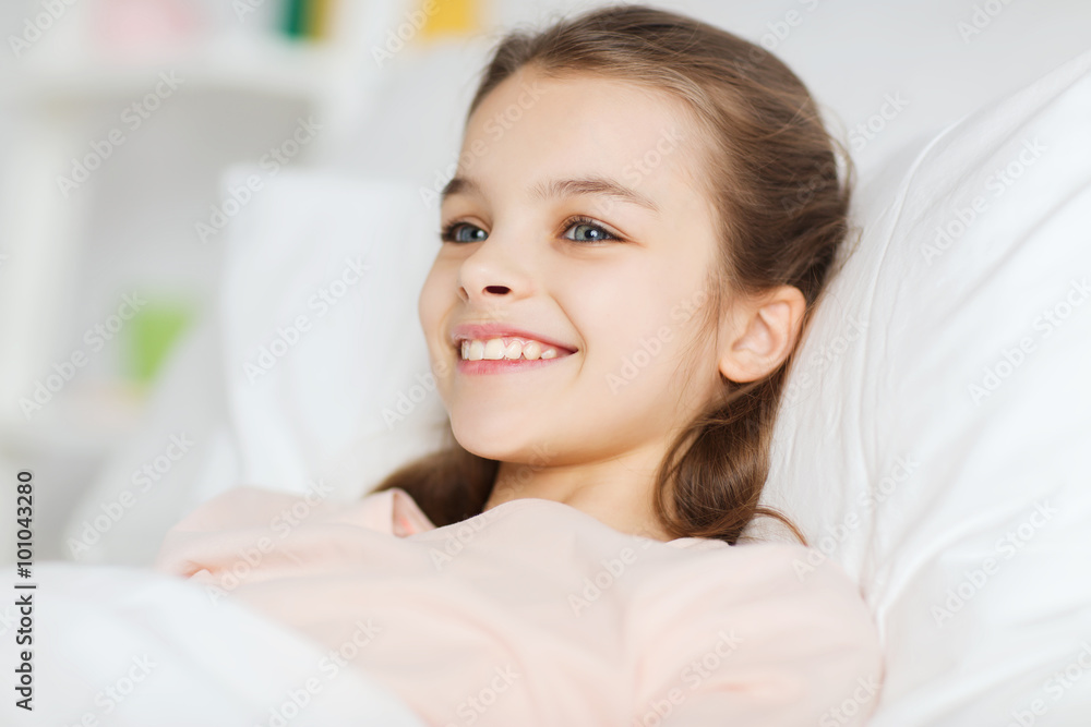 Poster happy smiling girl lying awake in bed at home