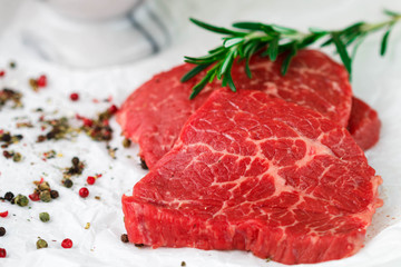 Raw fresh steaks from the marble beef, rosemary and spices