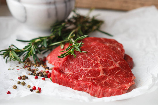 Raw fresh steaks from the marble beef, rosemary and spices