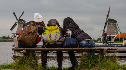 Female Backpackers in front of traditional dutch windmills