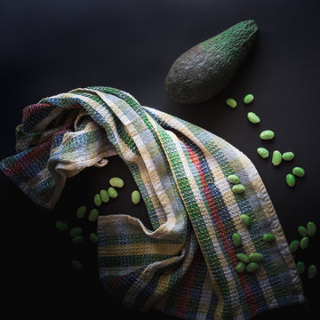 representation of avocado and soy beans called edamame set on dark background, filtered with vintage colors