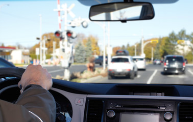 Hand of man driving on a highway.