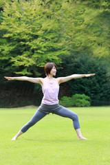 Fototapeta na wymiar Japanese woman doing yoga warrior II pose