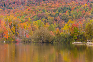 Fototapeta premium Autumn foliage and reflection in Vermont, Elmore state park