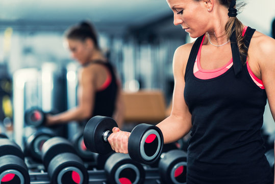 Exercising In Front Of The Mirror In Modern Gym 