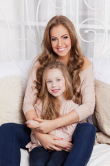 Beautiful woman and child at home