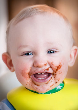 Happy joyful child taste sweet dessert, laughing and smiling.