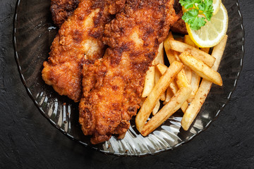 Fried fish in crispy batter with chips
