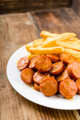 currywurst mit pommes auf einen holzuntergrund