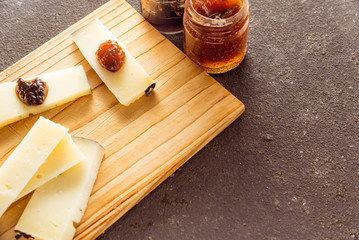 Some sliced typical Pecorino cheese with multilored jams
