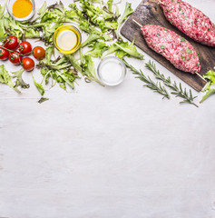 Crude kebab on a skewer with vegetables on a cutting board border ,place for text  on wooden rustic background top view close up