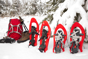 Red backpack  , snowshoes  for a difficult winter hike in the mountains.