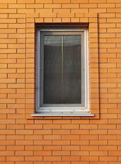 Close-up on single plastic window sill detail on brick wall. Ins