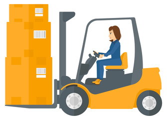 Worker moving load by forklift truck.