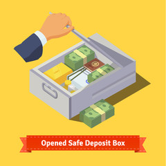 Hand opening a safe deposit box full of valuables