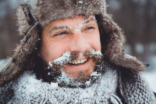 Portrait of a young handsome man with a beard. 
Bearded man in winter.
