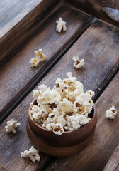 Fototapeta na wymiar popcorn in a wooden plate on the background