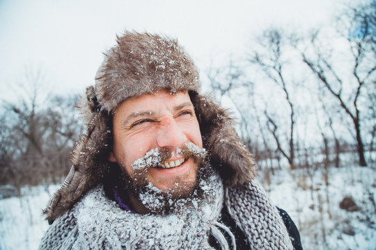 Portrait of a young handsome man with a beard. 
Bearded man in winter.
