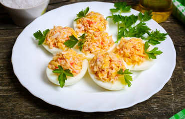 Eggs stuffed with crab and cheese on a wooden table