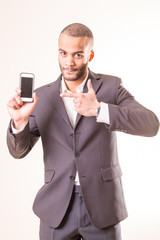 african man in suit holding  smartphone