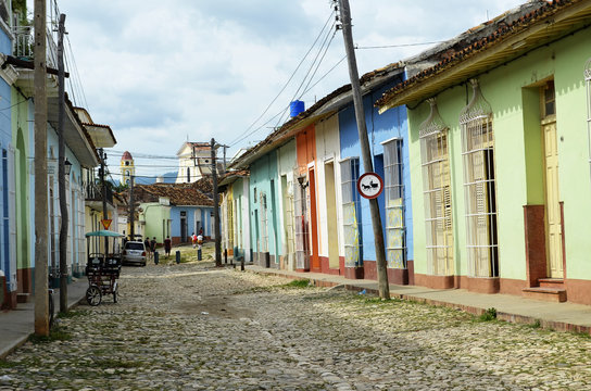 Typical street in Trinidad (Cuba), with coloured houses and Saint Francis church as a background.