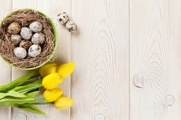 Easter with eggs and yellow tulips