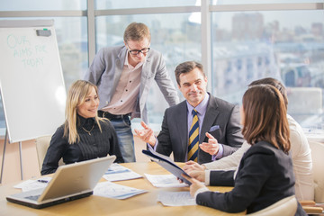Five business people working together in the office