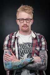 red-haired guy with glasses, tattoos on the hands