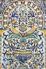 Fototapeta na wymiar Tunisia. Kairouan - the Zaouia of Sidi Saheb. Fragment of ceramic tiled panel with floral and architectural motifs