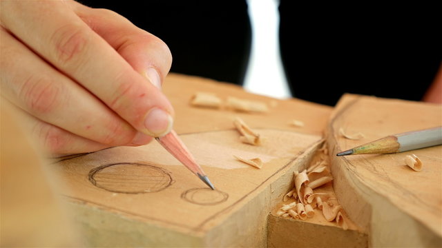 Wood carving - Human hand drawing over a piece of wood