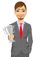 business man winner holding a silver cup trophy