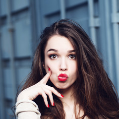 Portrait of a beautiful brunette girl with a surprised look