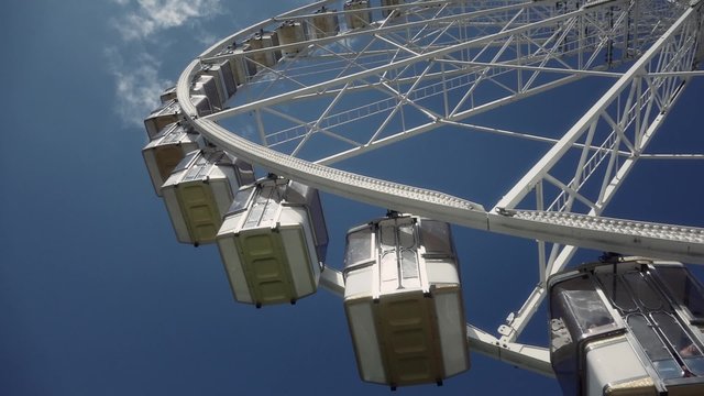 Ferris wheel amusement park - pan 60fps. The Fete foraine du Jardin des Tuileries is a small amusement park that is set up every summer in the Tuileries Gardens