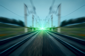 Fototapeta na wymiar Green light on railway motion blurred abstract background