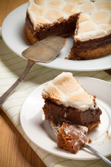 Sweet cake with chocolate on a light wooden table. Selective foc