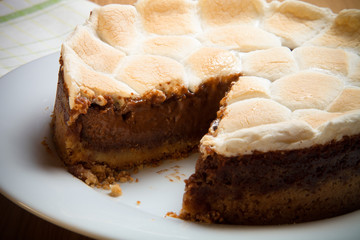 Sweet cake with chocolate on a light wooden table. Selective foc