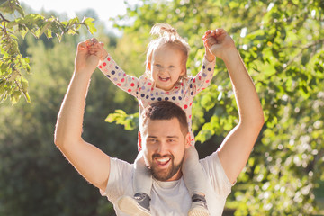 Happy Father and toddler have fun in park