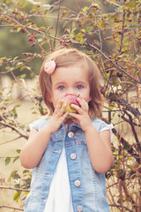 Cute toddler eating apple