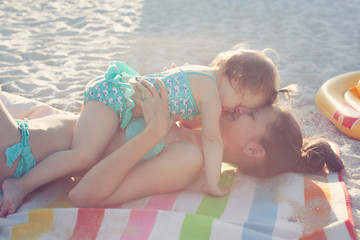 Mother and daughter have fun on the beach