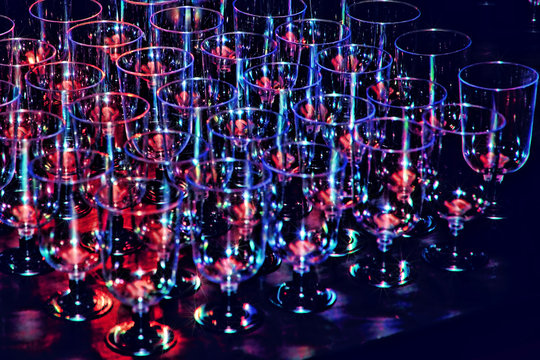 A row of wineglasses on holiday reception table in multicolored