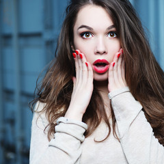 Portrait of a beautiful brunette girl with a surprised look