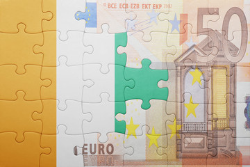 puzzle with the national flag of cote divoire and euro banknote