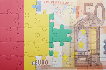 puzzle with the national flag of guinea and euro banknote