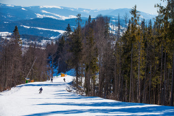 Chairs on chairlift ropeway in winter mountains