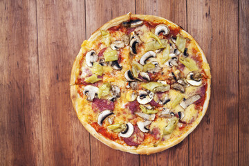 pizza isolated on a wooden background