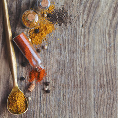 Powder spices on spoon in gray wooden table background