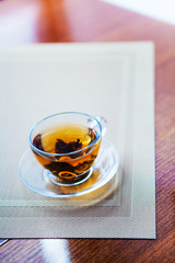 Cup of tea and mint on a wooden background